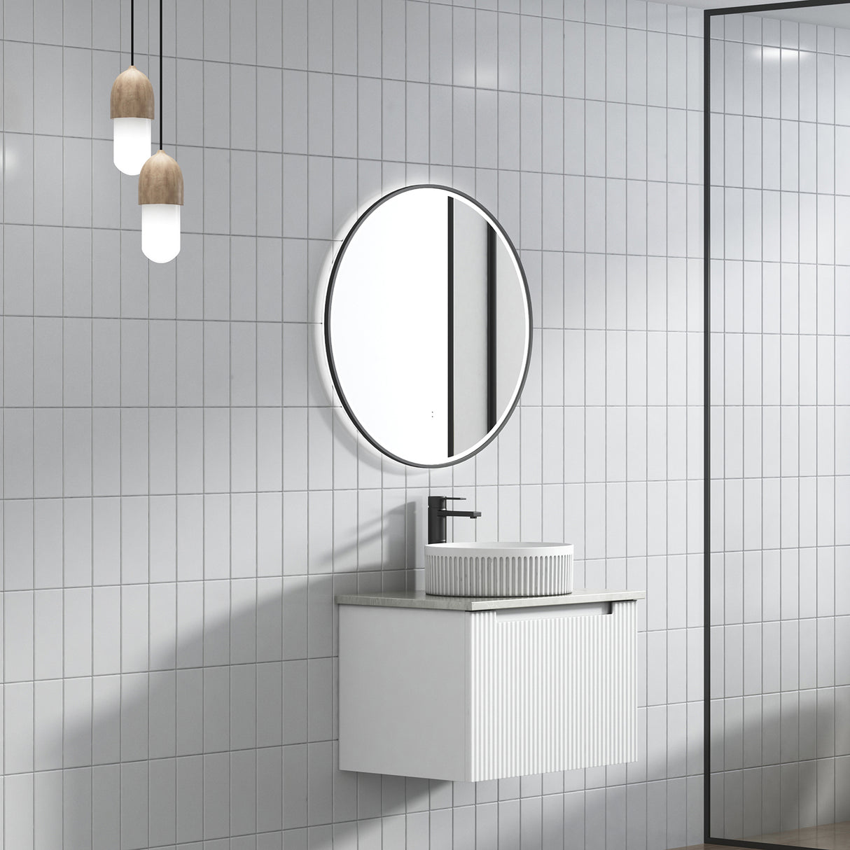 Bathroom with round mirror, sink, and tiled walls