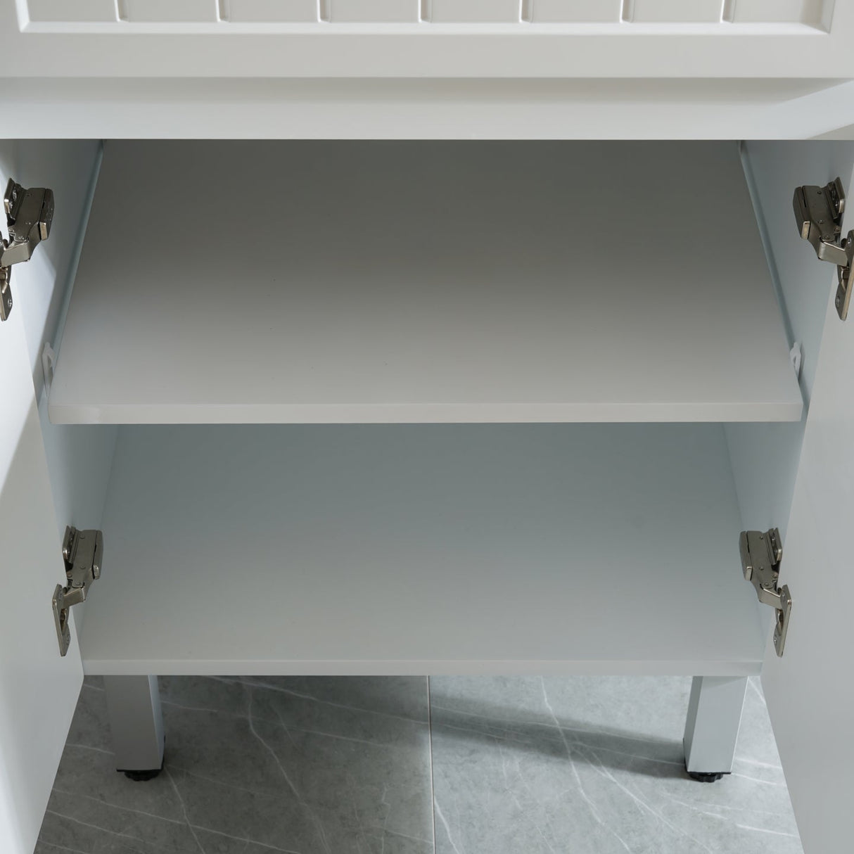 White cabinet with open drawer on a gray tiled floor