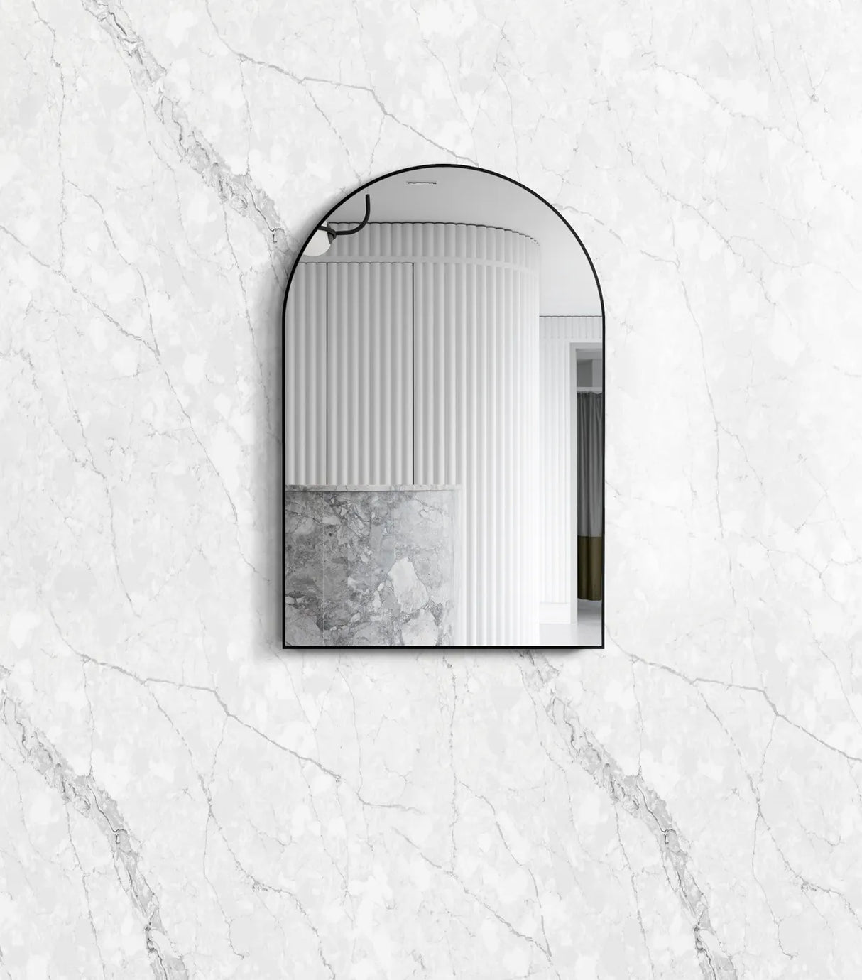 Arch-shaped mirror on a marble wall