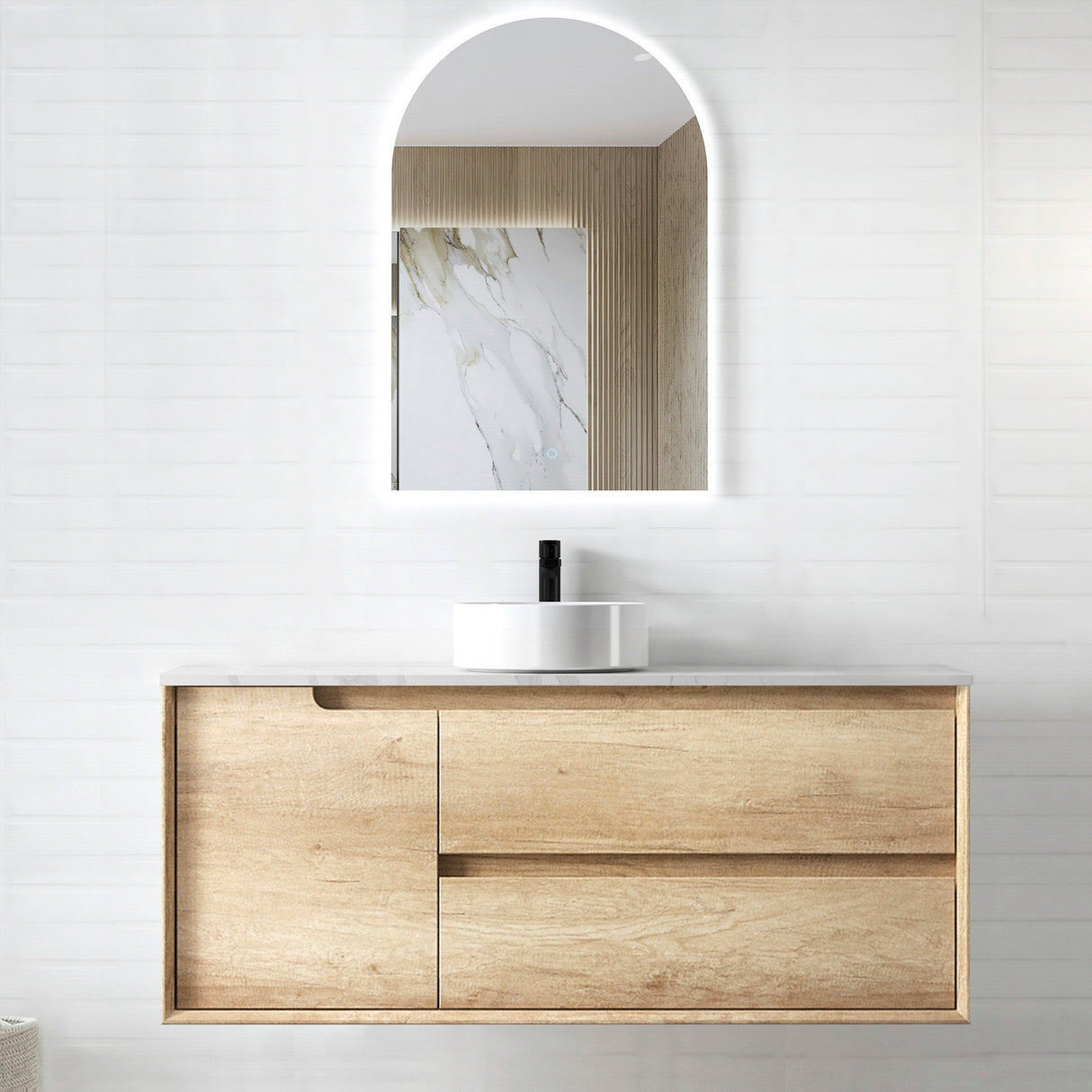 Bathroom vanity with wooden cabinet, mirror, and sink on a white wall.
