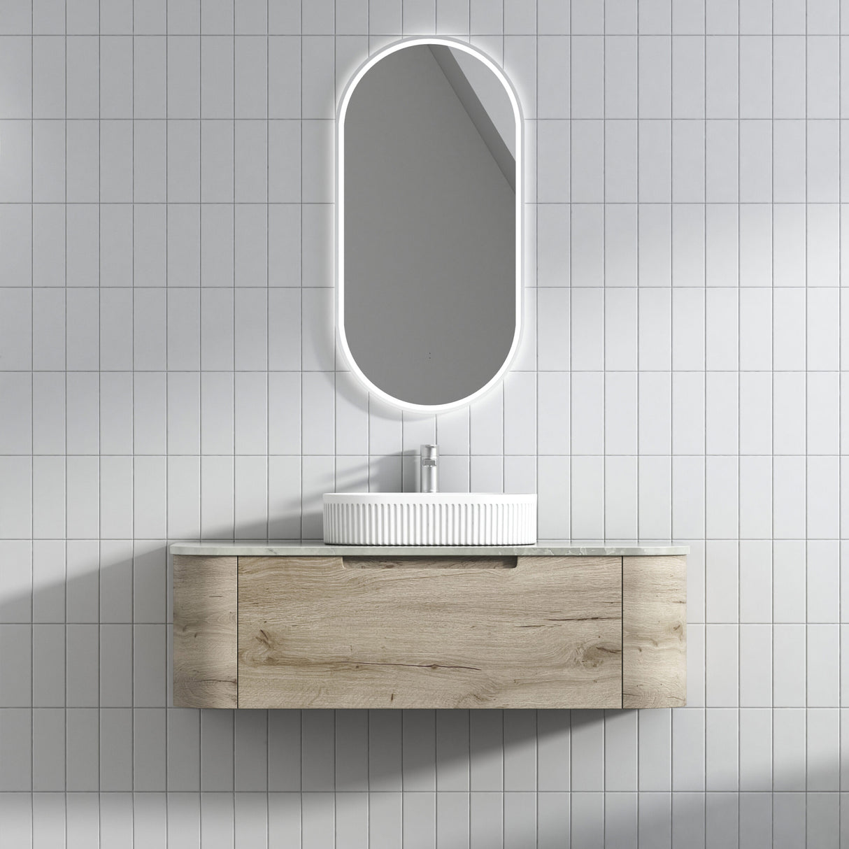 Bathroom vanity with sink and mirror against a tiled wall
