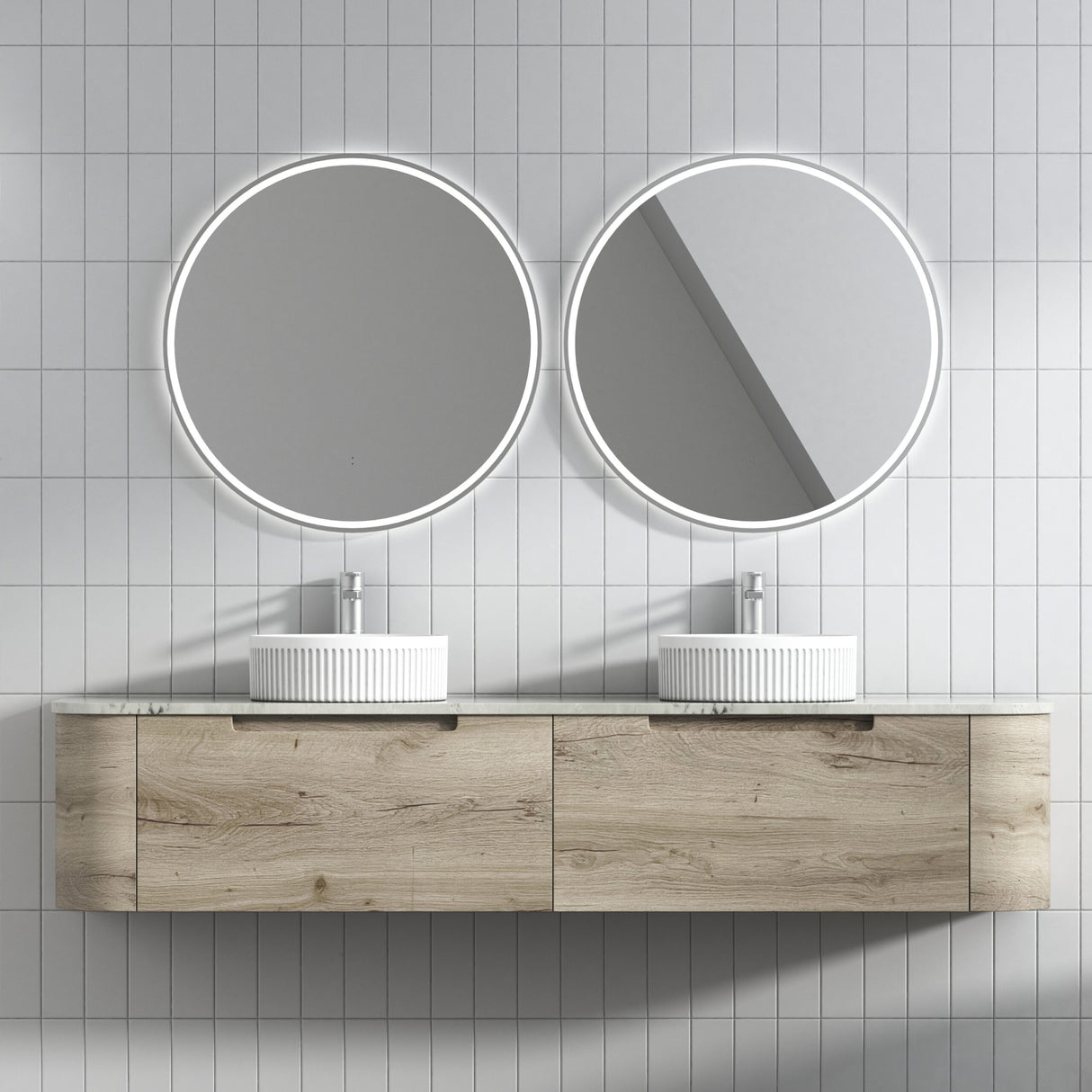 Bathroom vanity with two round mirrors and white sinks against a tiled wall.