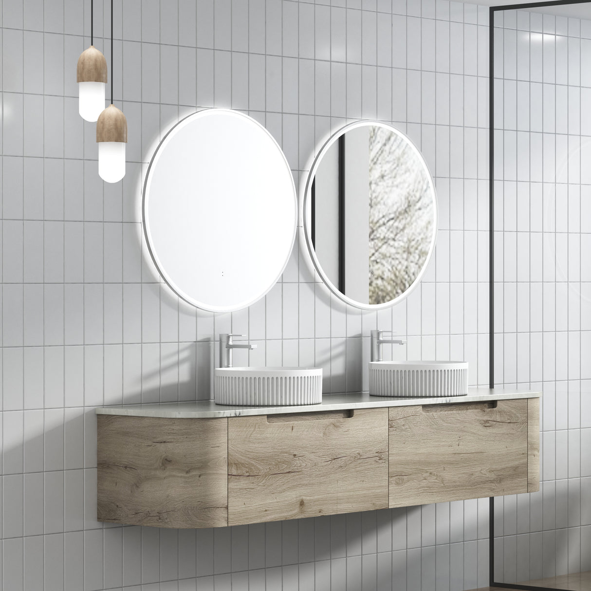 Bathroom vanity with two round mirrors and wooden cabinets against a tiled wall.