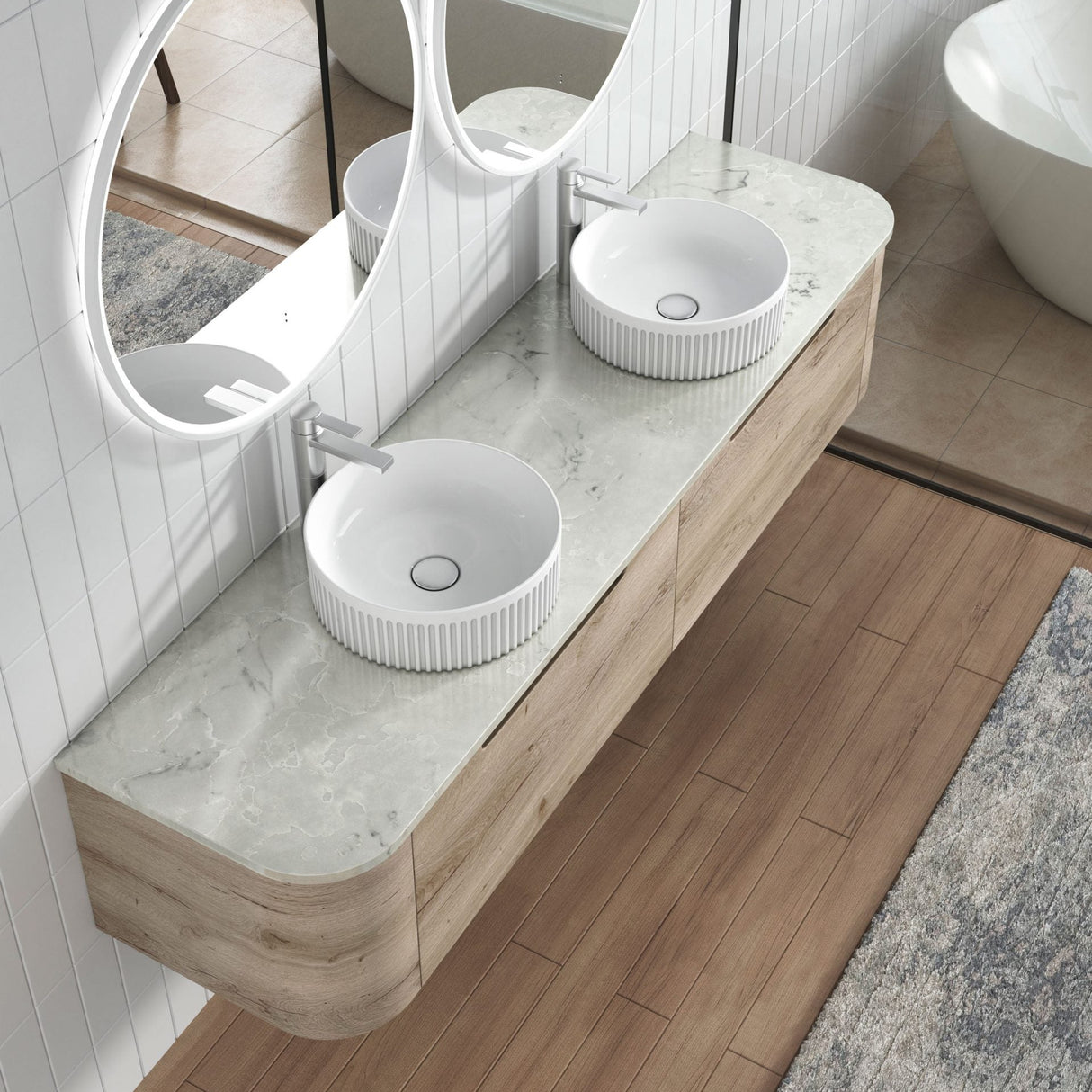 Bathroom vanity with two white sinks and a large round mirror.