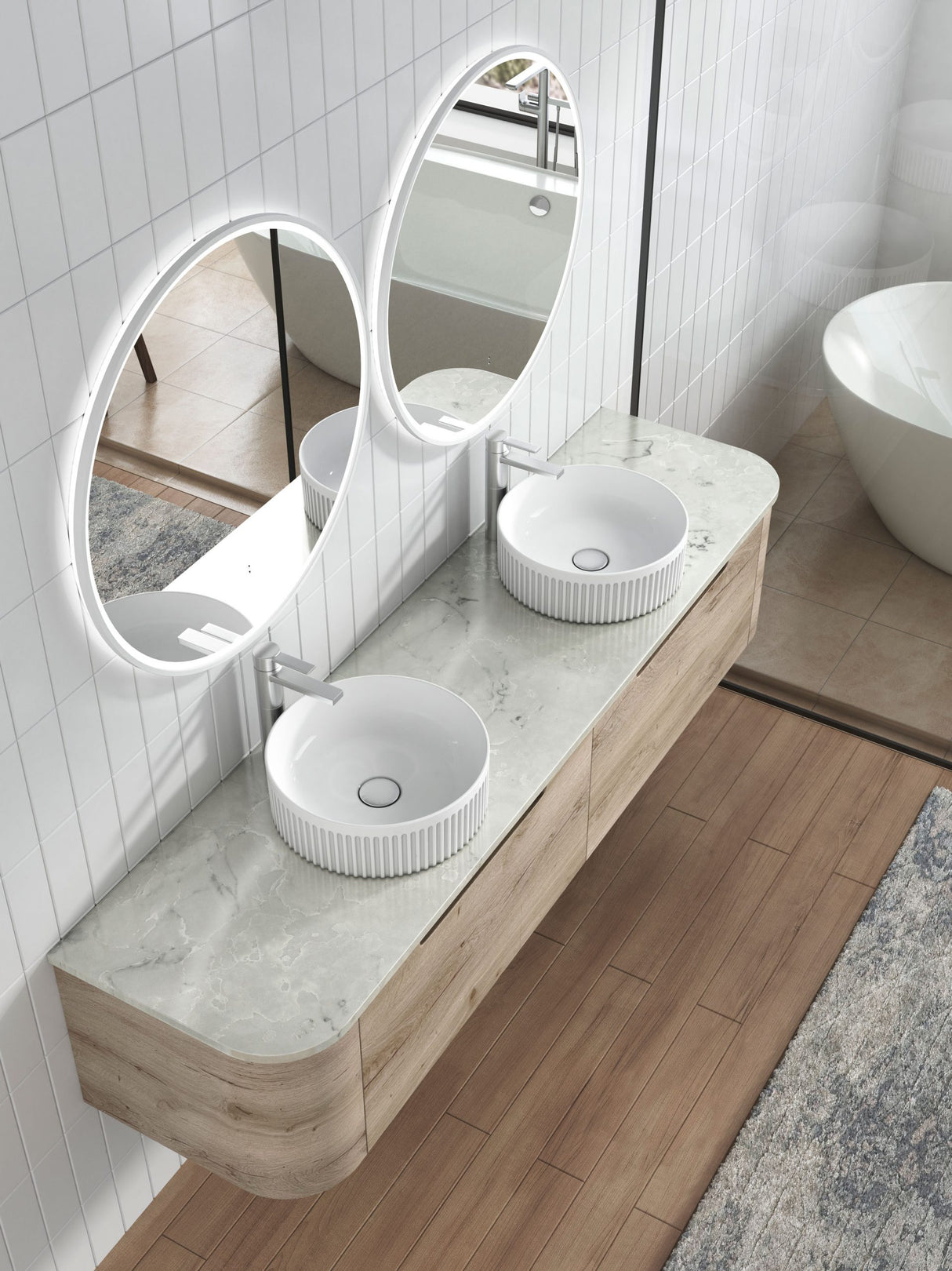 Bathroom vanity with two white sinks and a large round mirror.