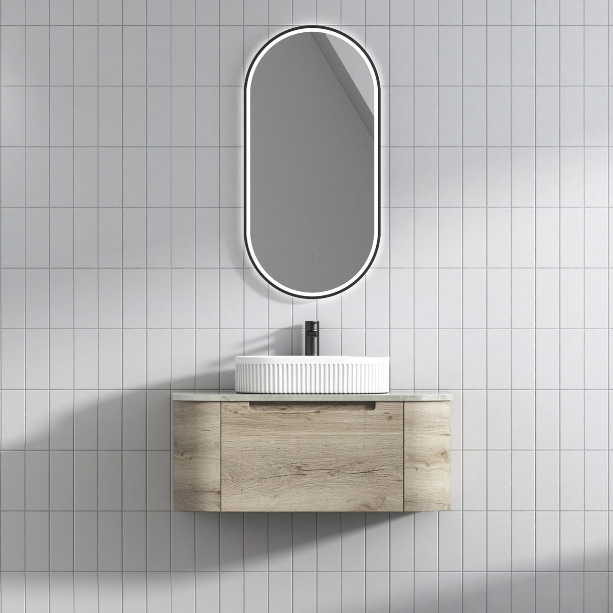 Bathroom vanity with sink and mirror on a tiled wall