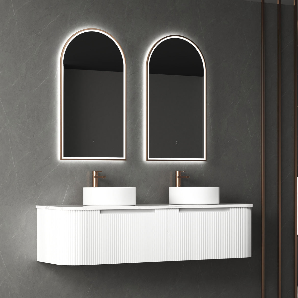 Bathroom vanity with two illuminated mirrors and white sinks on a dark gray wall.
