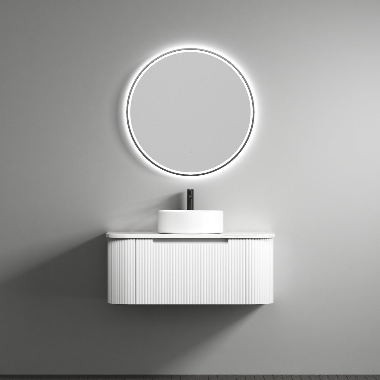 Modern bathroom vanity with round mirror and light on a gray wall.