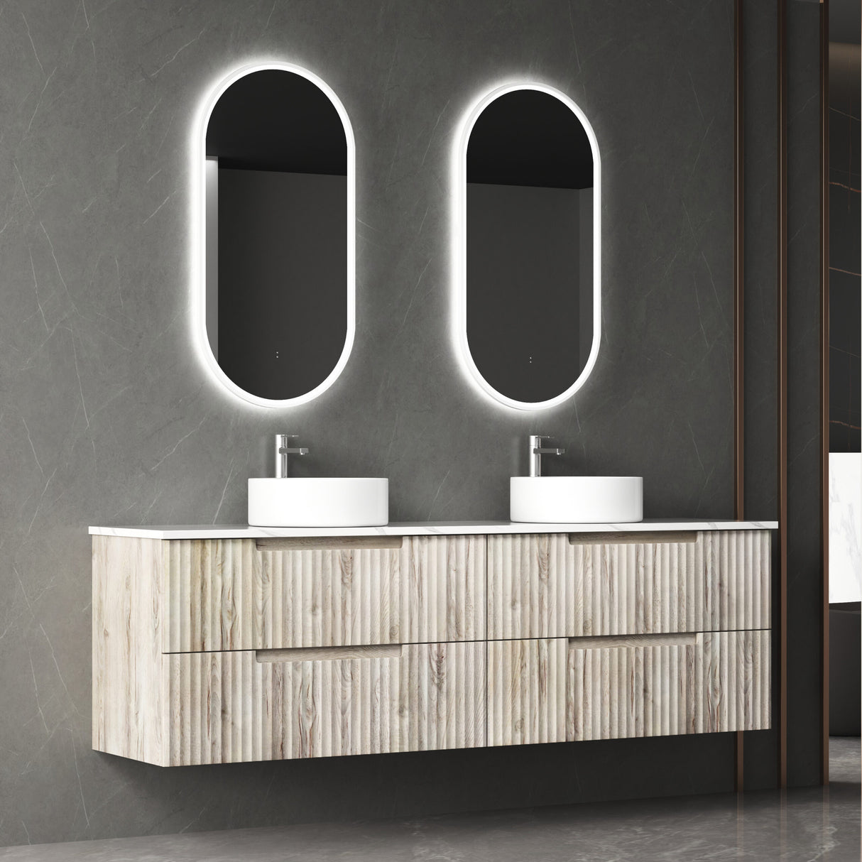 Bathroom vanity with double sink and illuminated mirrors against a gray wall.