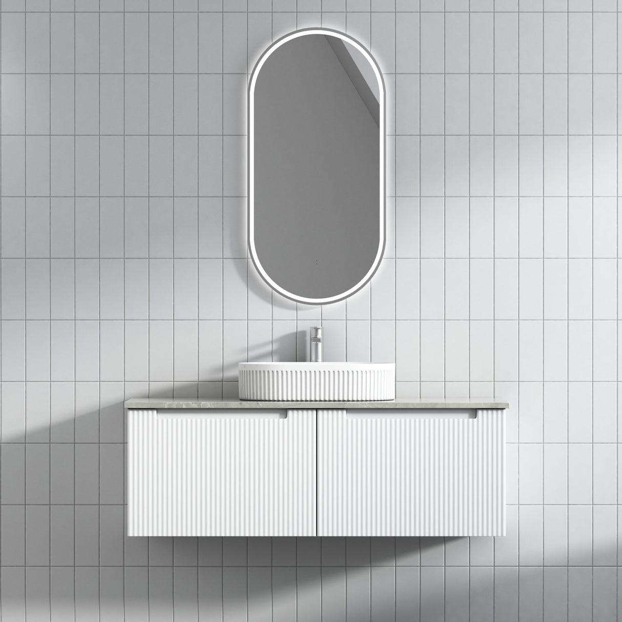 Bathroom vanity with sink and mirror against a tiled wall