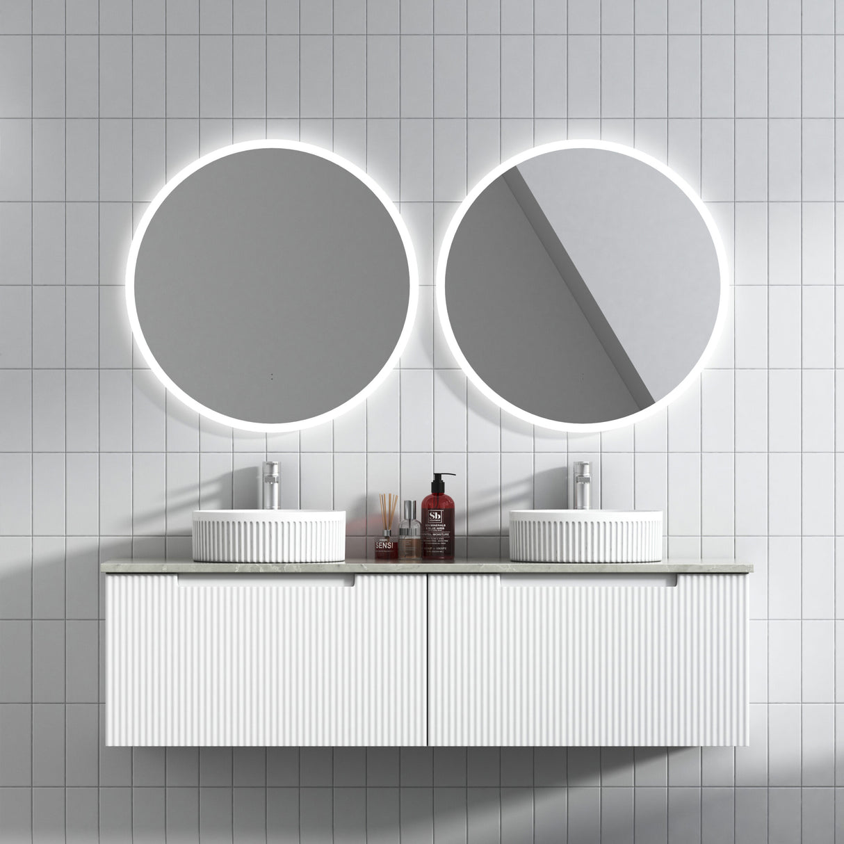 Bathroom vanity with round mirrors and lighting, featuring a tiled wall.