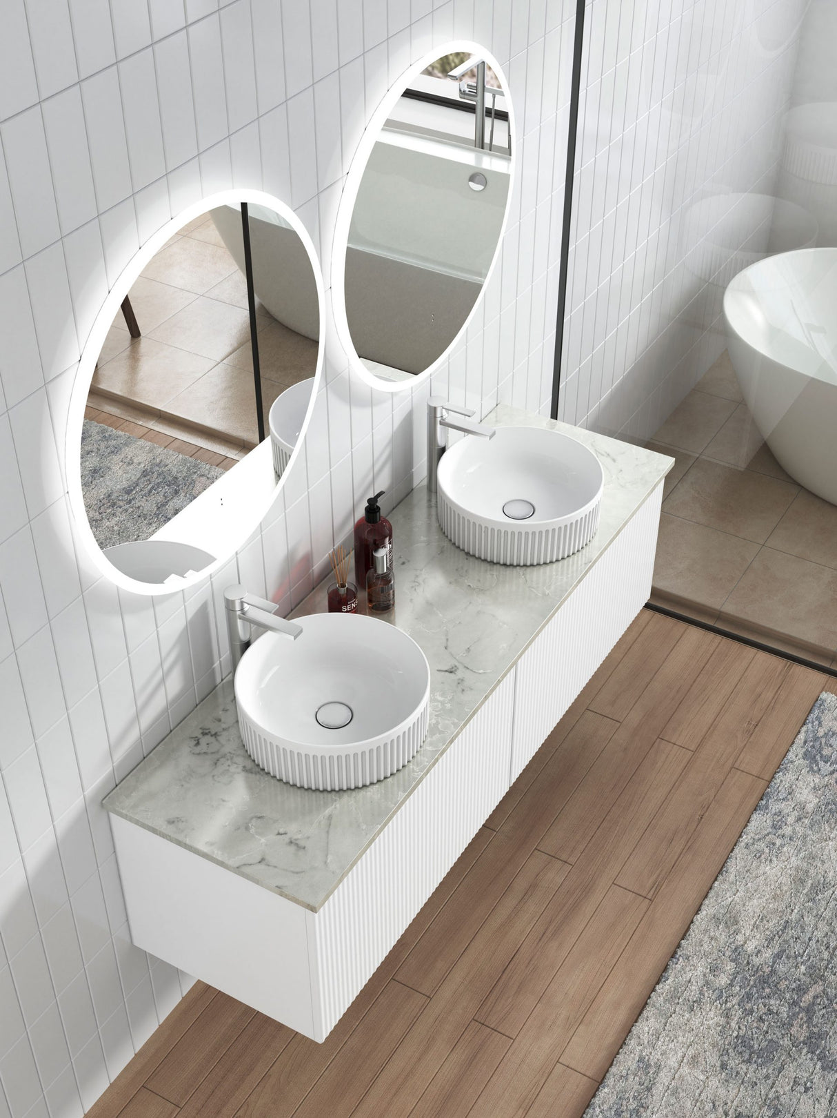 Bathroom vanity with two round sinks and a large mirror in a modern bathroom setting.