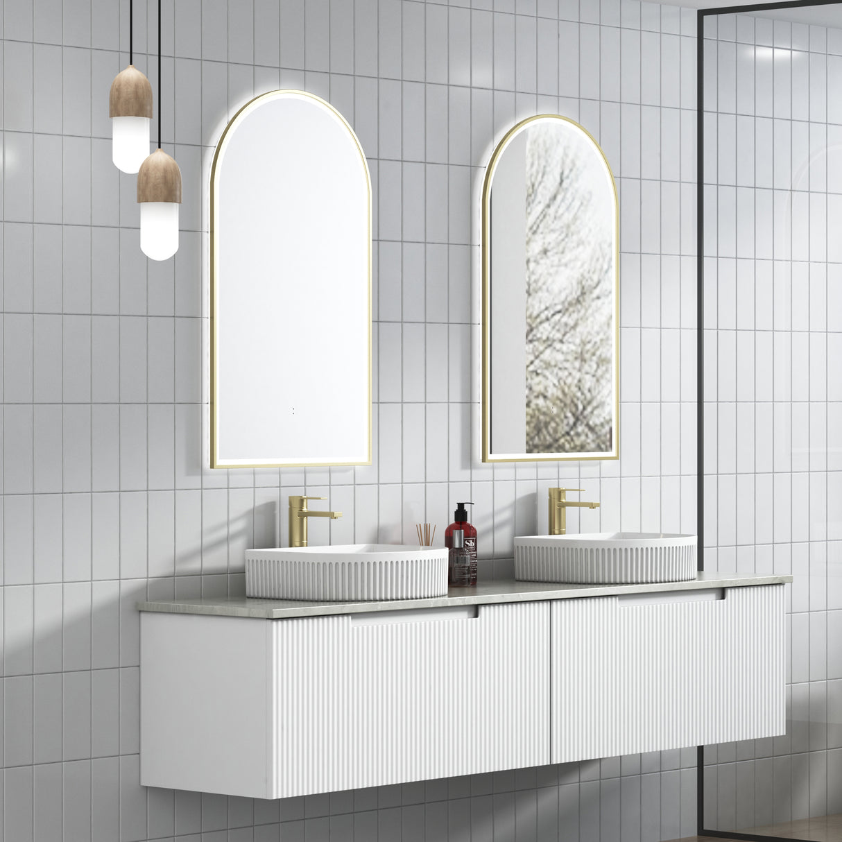 Bathroom vanity with two mirrors and a faucet against a tiled wall.