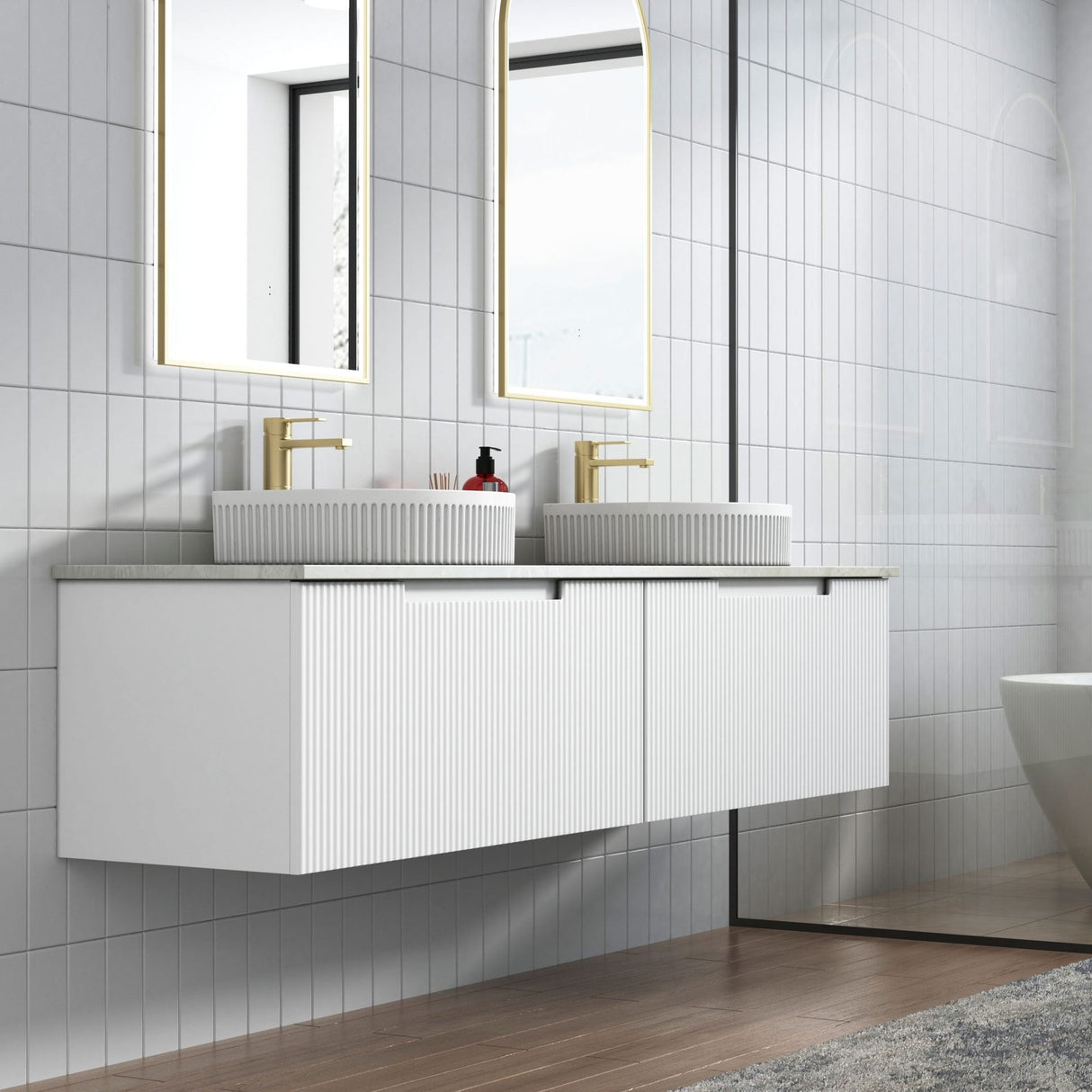 Modern bathroom with white vanity, mirrors, and a bathtub.