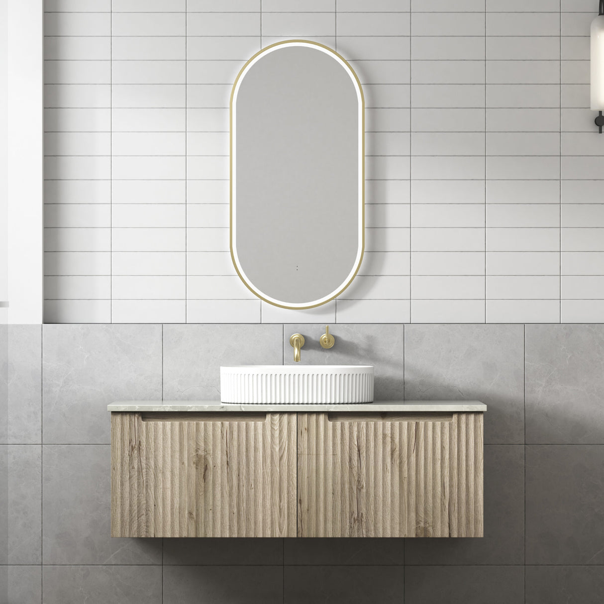 Bathroom vanity with a sink and mirror against a tiled wall.