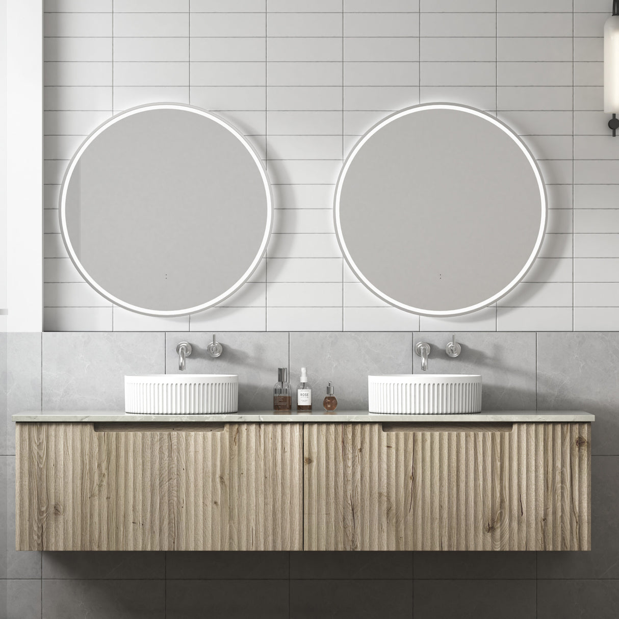 Bathroom vanity with two round mirrors and a wooden cabinet.