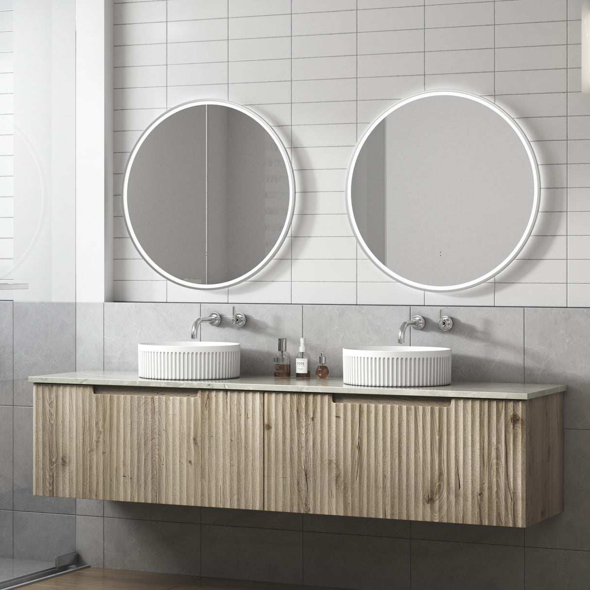 Bathroom vanity with two round mirrors and a wooden cabinet.