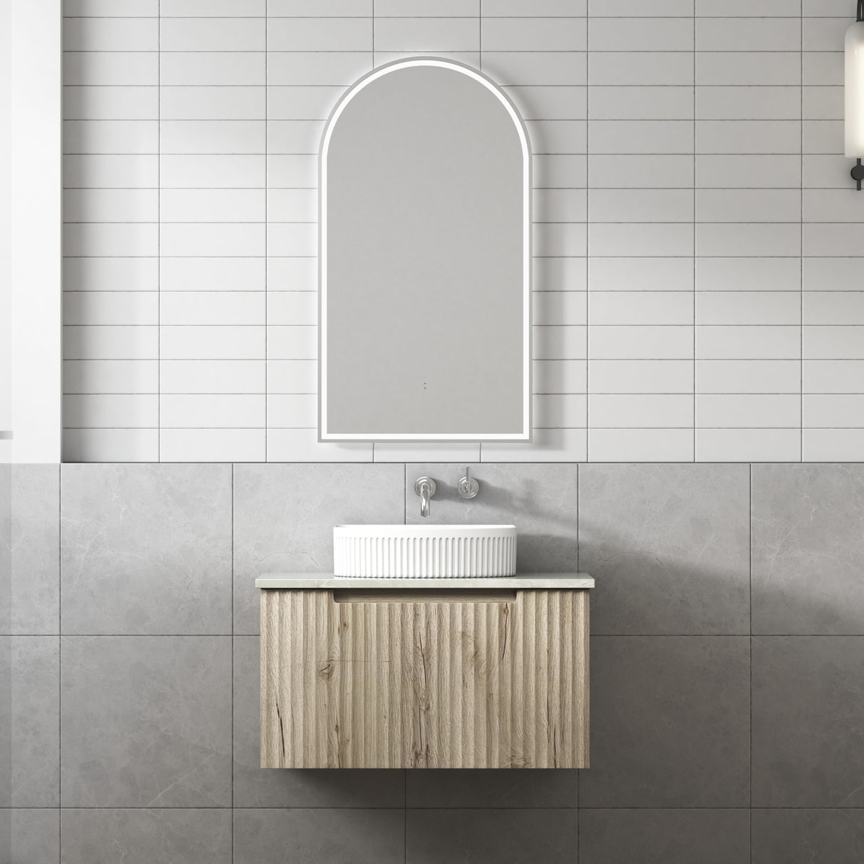 Bathroom vanity with a mirror and sink against tiled walls.