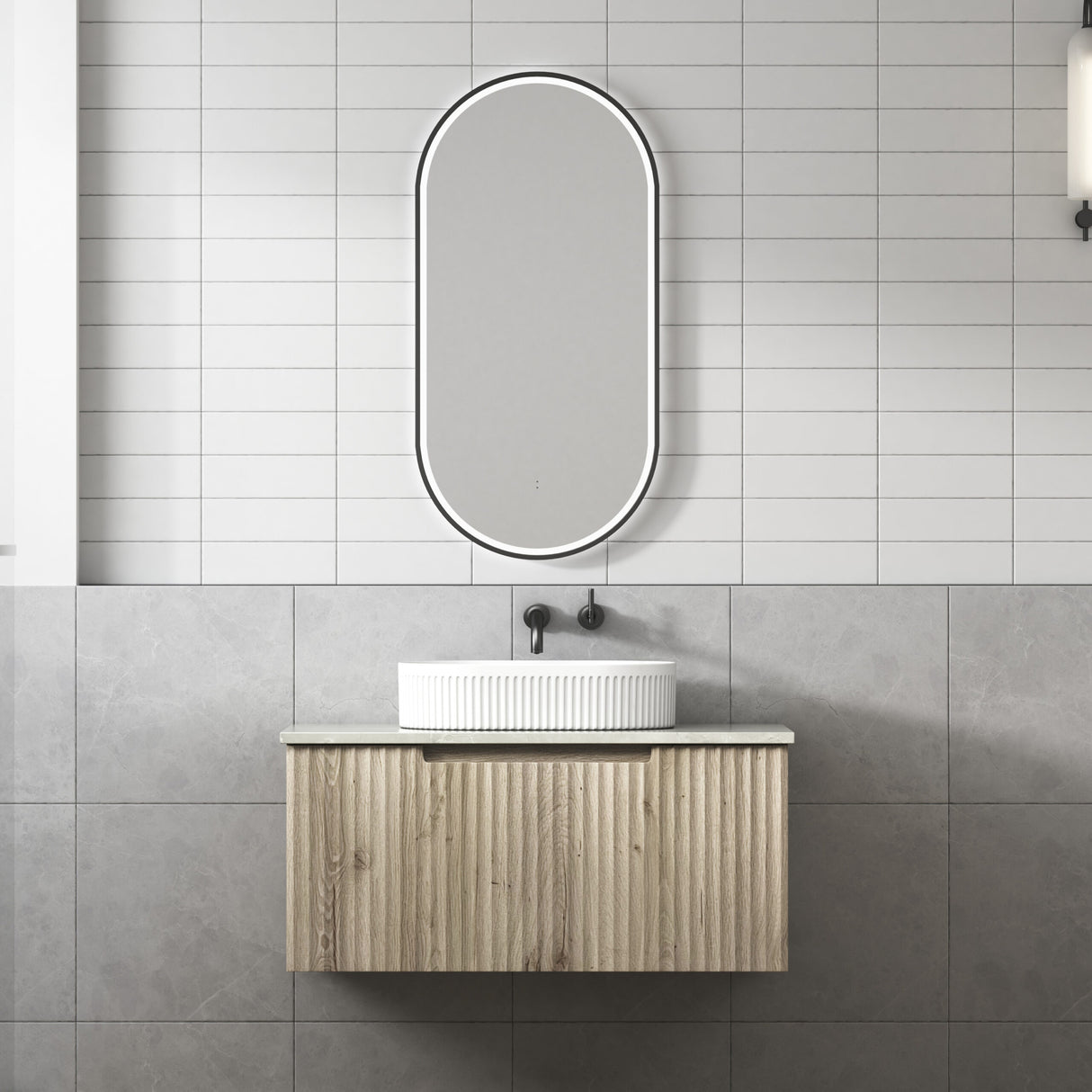 Bathroom vanity with a sink and mirror against tiled walls