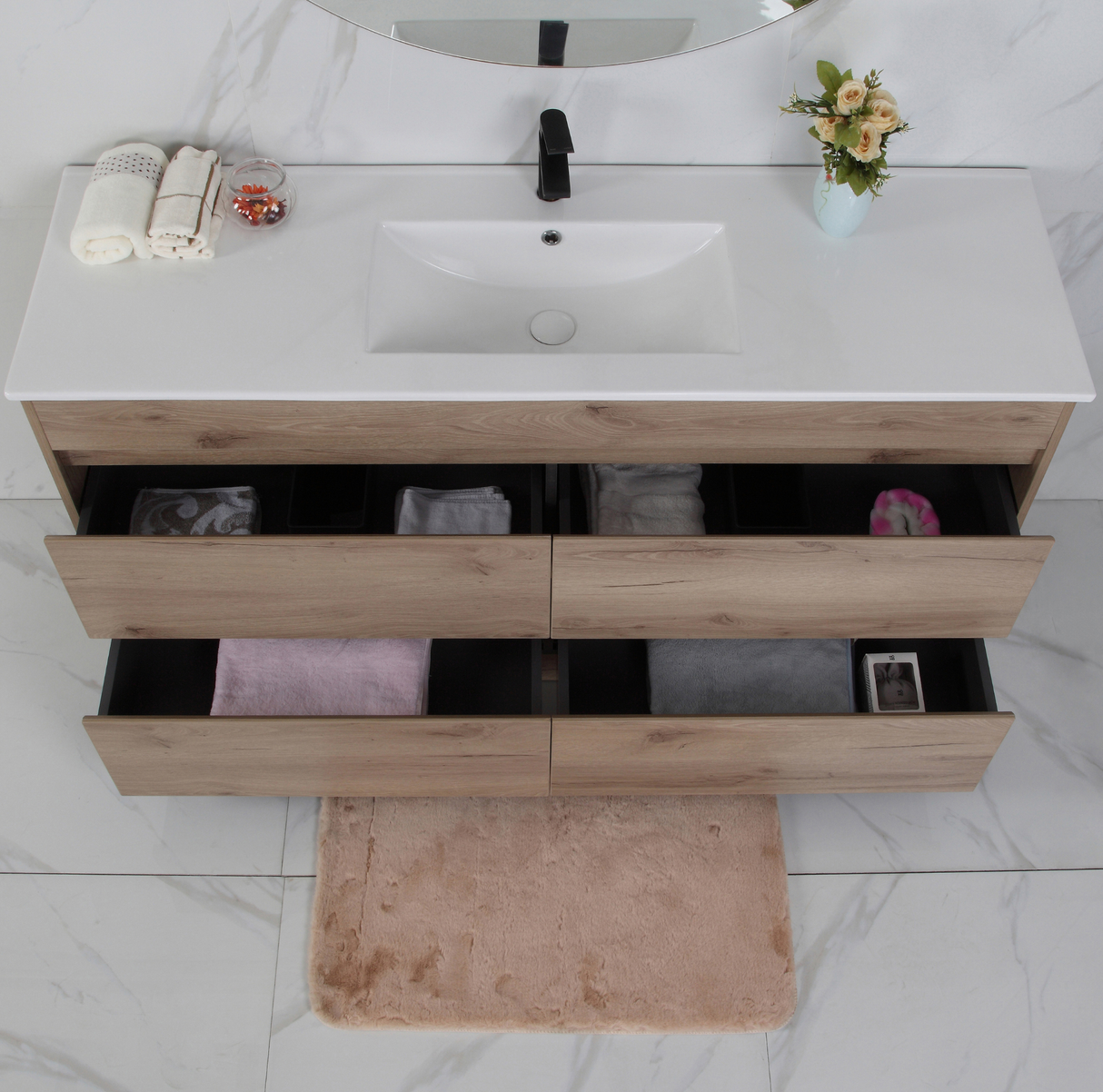 Bathroom vanity with wooden drawers and white countertop
