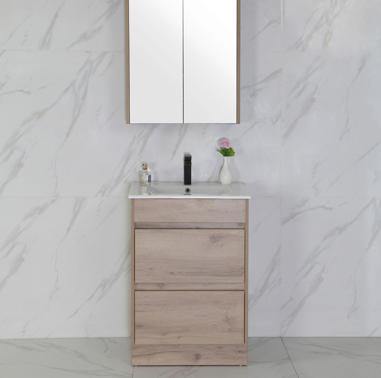 Bathroom vanity with mirror and sink against a marble wall.