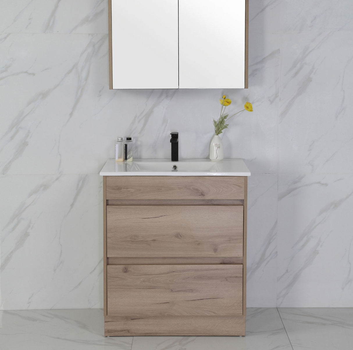 Bathroom vanity with wooden cabinet, white countertop, and decorative elements against a marble wall.