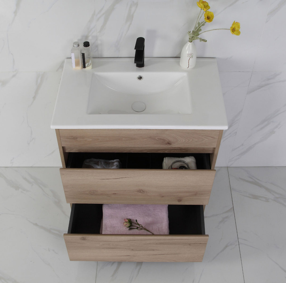 Bathroom vanity with sink, drawers, and decorative elements on a marble floor.