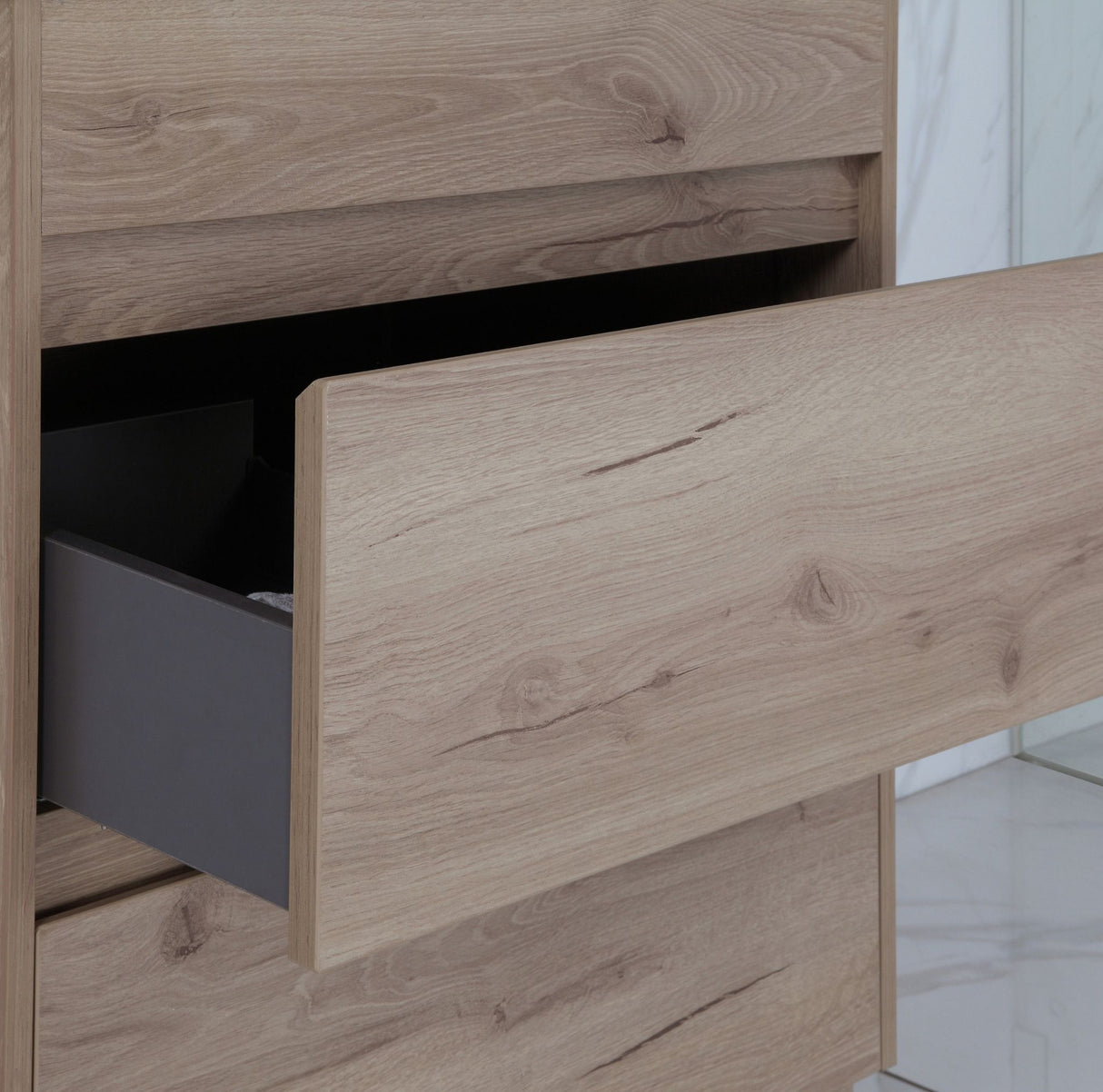 Wooden drawer with a gray interior on a wooden cabinet.
