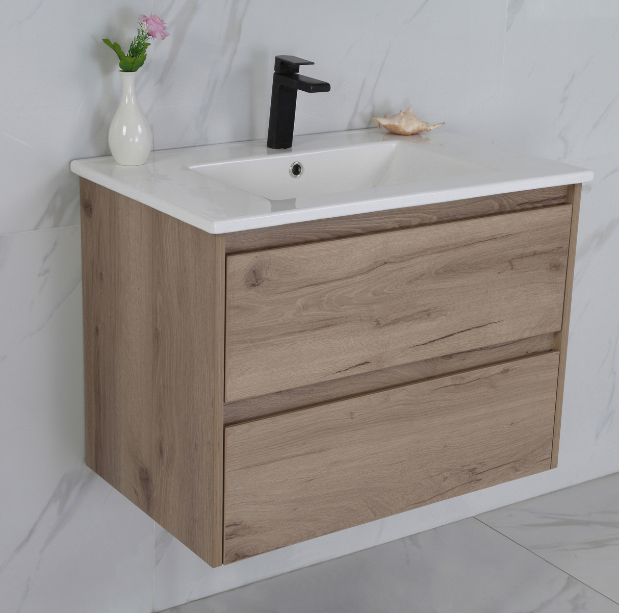 Bathroom vanity with wooden cabinet, white countertop, and black faucet.