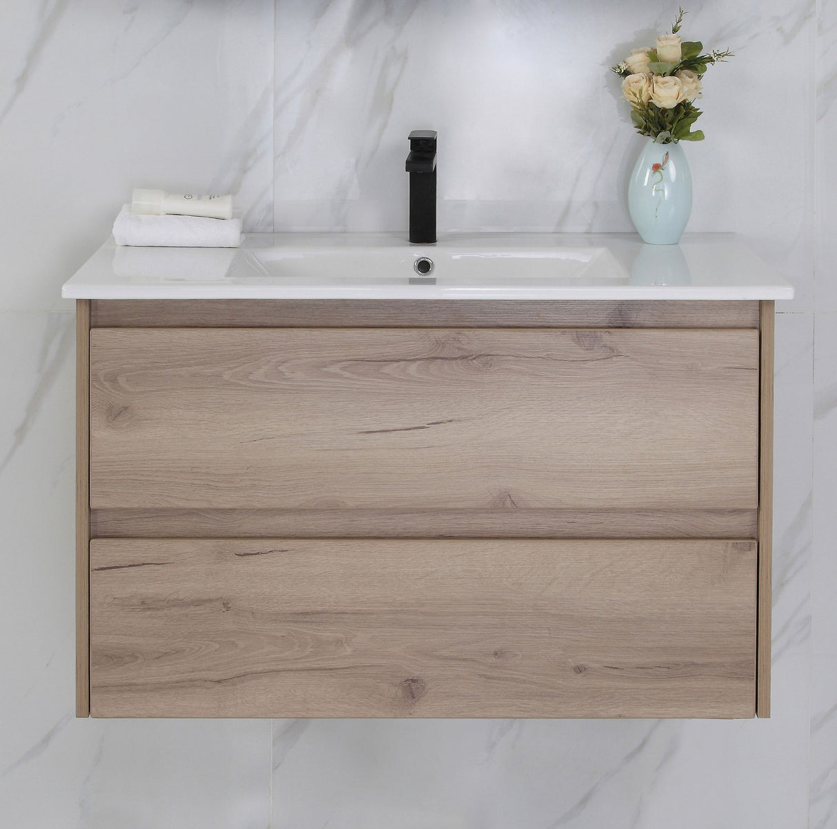 Bathroom vanity with wooden finish, white countertop, and decorative elements.