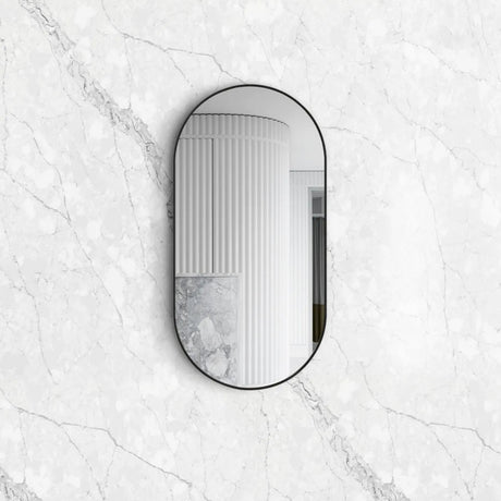 Noosa Oval Black Framed Mirror mounted in the bathroom