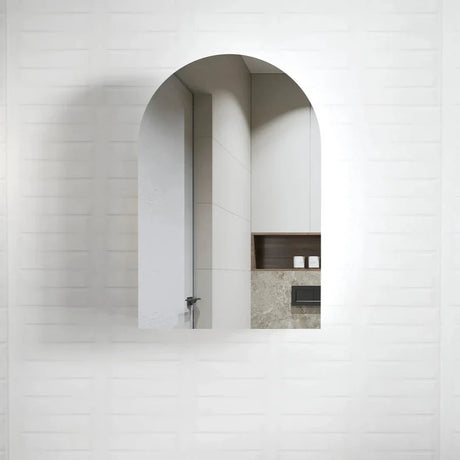 Otti Arched Matte White Shaving Cabinet featuring a minimalist arched design with a sleek matte white finish, seamlessly integrated into a contemporary bathroom setting with neutral tones.