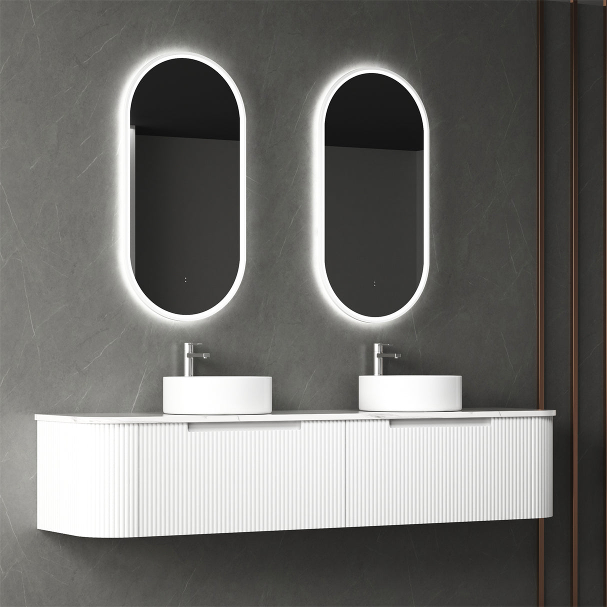 Bathroom vanity with two illuminated oval mirrors on a gray wall.
