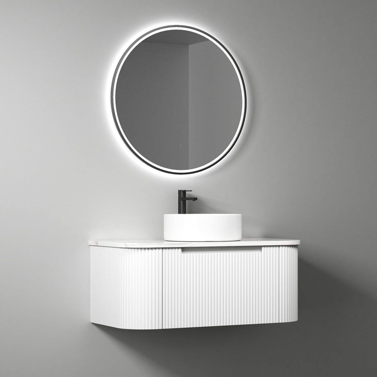 Bathroom vanity with round mirror and sink on a gray wall