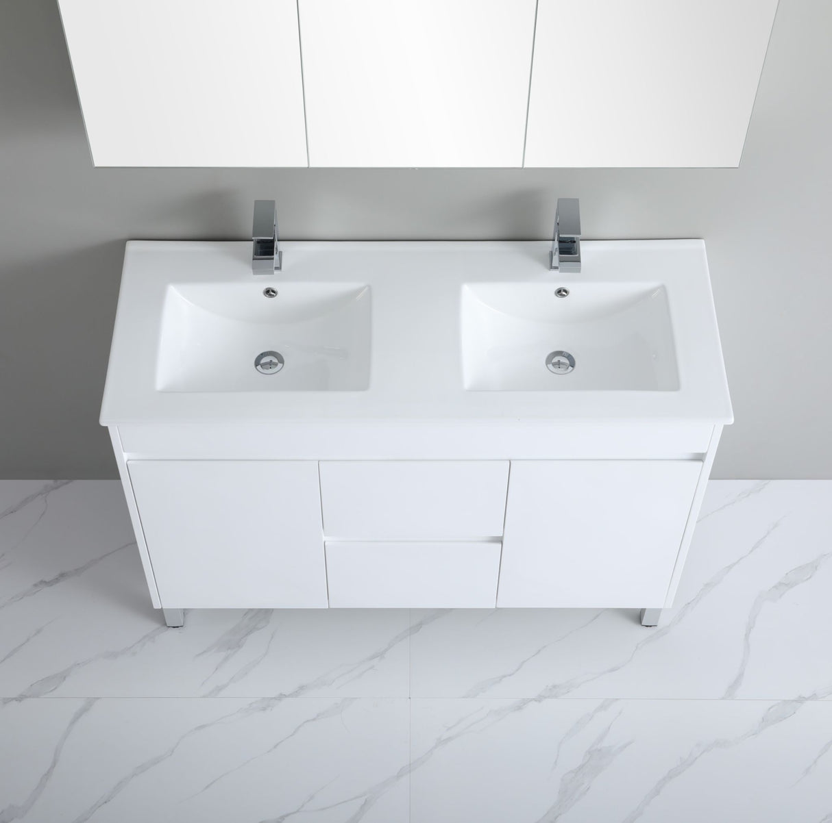 White bathroom vanity with double sink and cabinets on a marble floor.