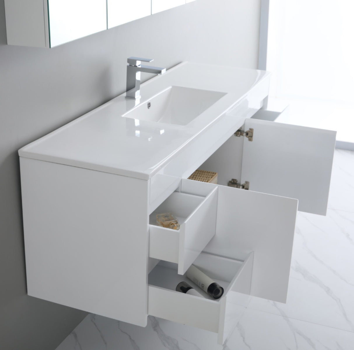 White bathroom vanity with open cabinet doors in a bright room.