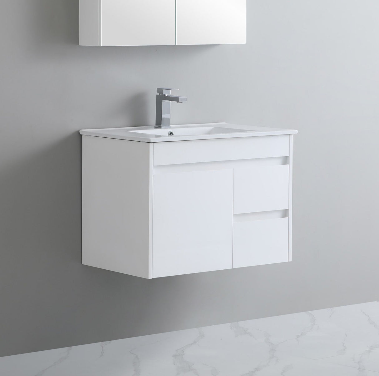 White bathroom vanity with sink and faucet on a gray wall.