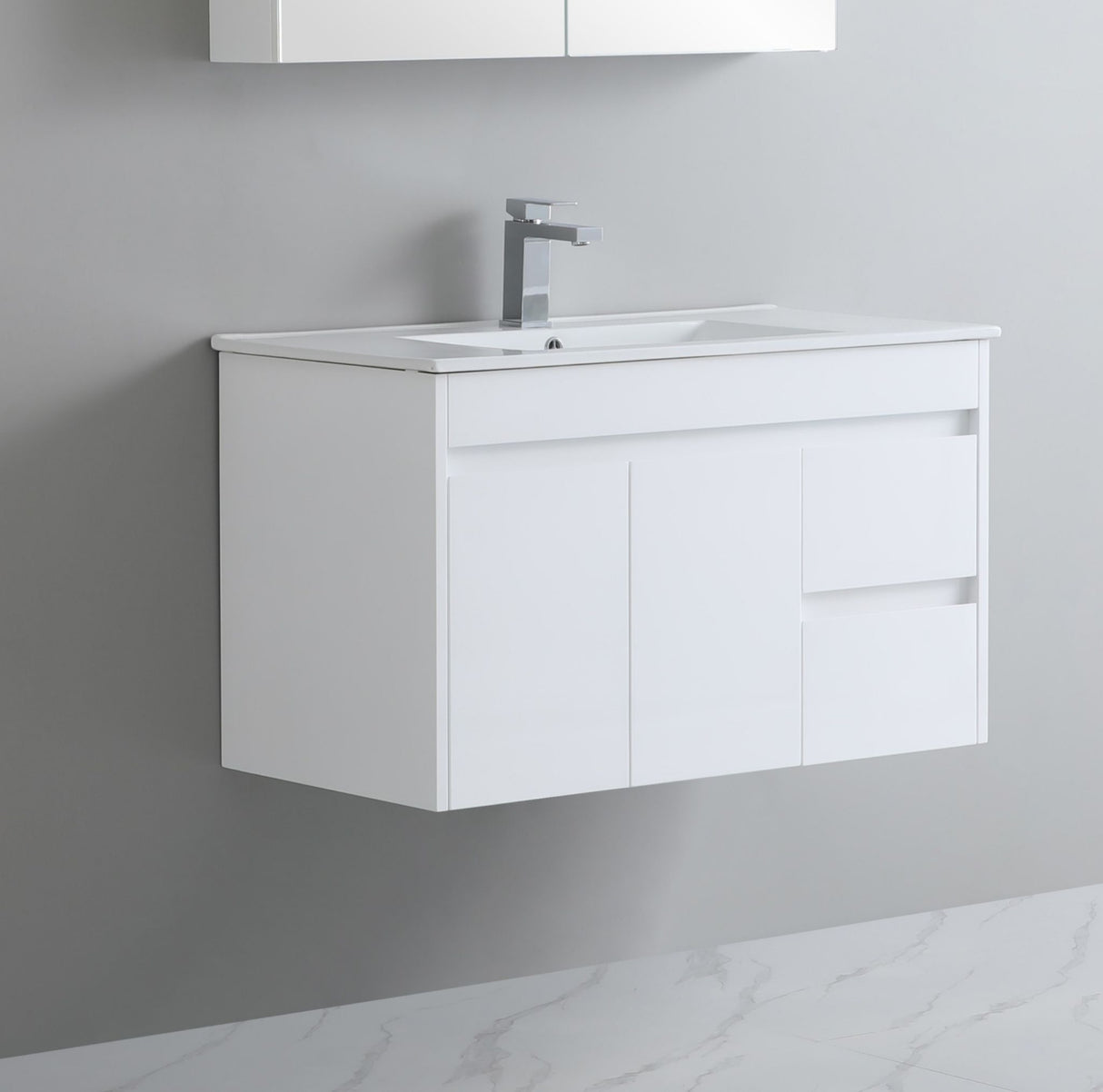 White bathroom vanity with sink and faucet against a gray wall.