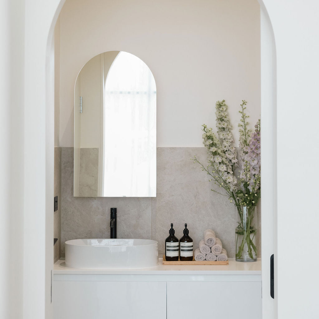 Bathroom interior with a sink, mirror, and decorative elements.