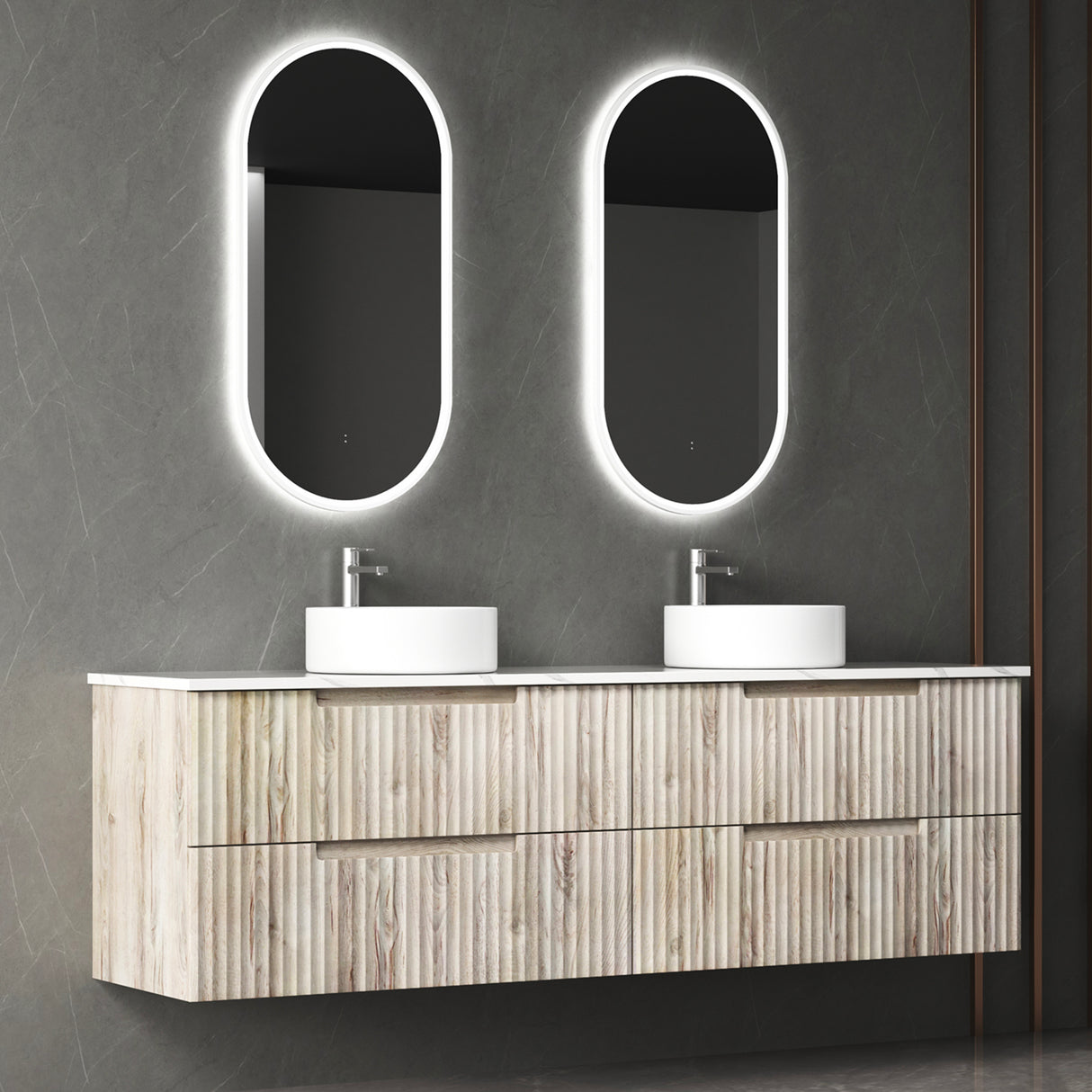 Bathroom vanity with double sink and illuminated mirrors against a gray wall.