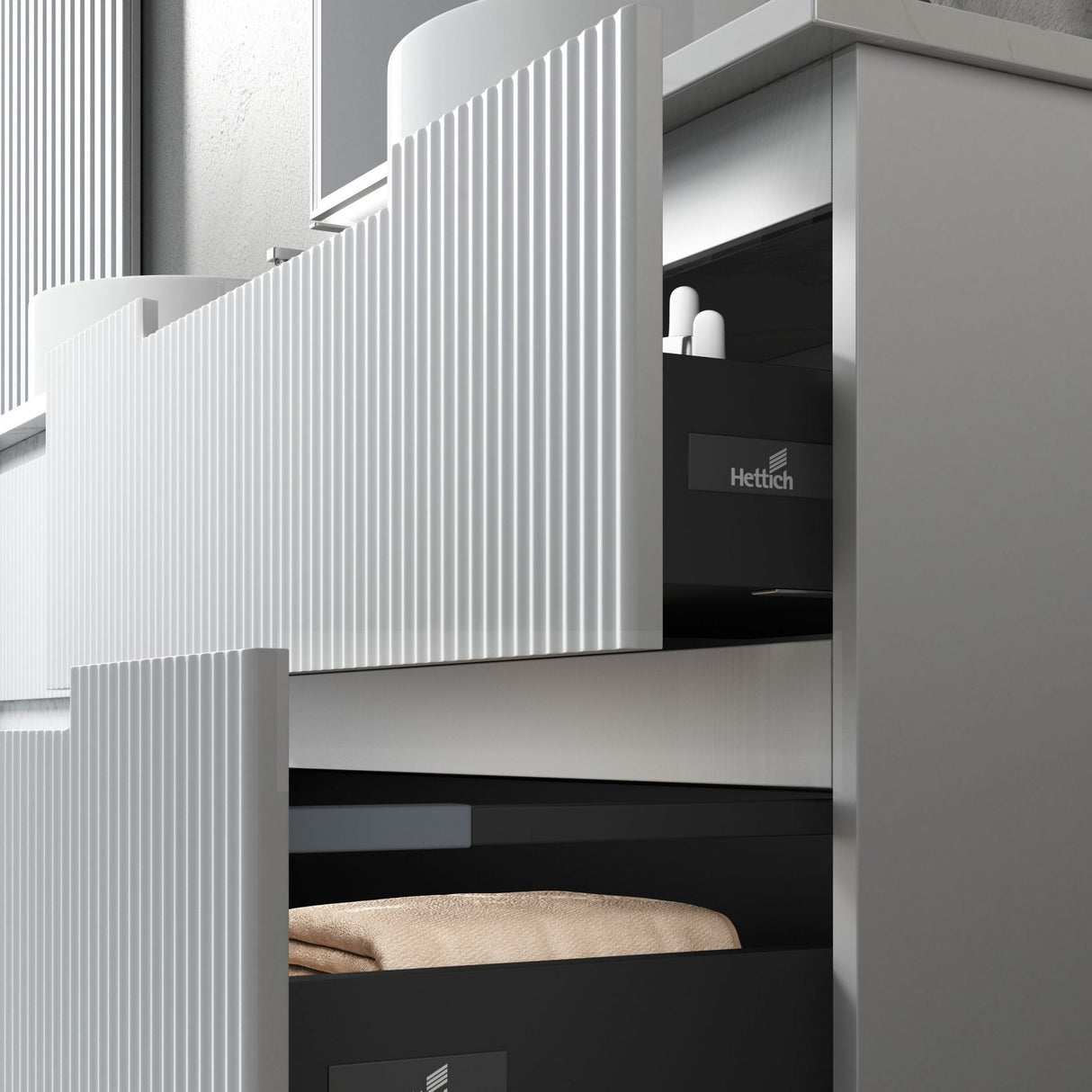 Modern kitchen cabinet with open drawer displaying Hettich branding.
