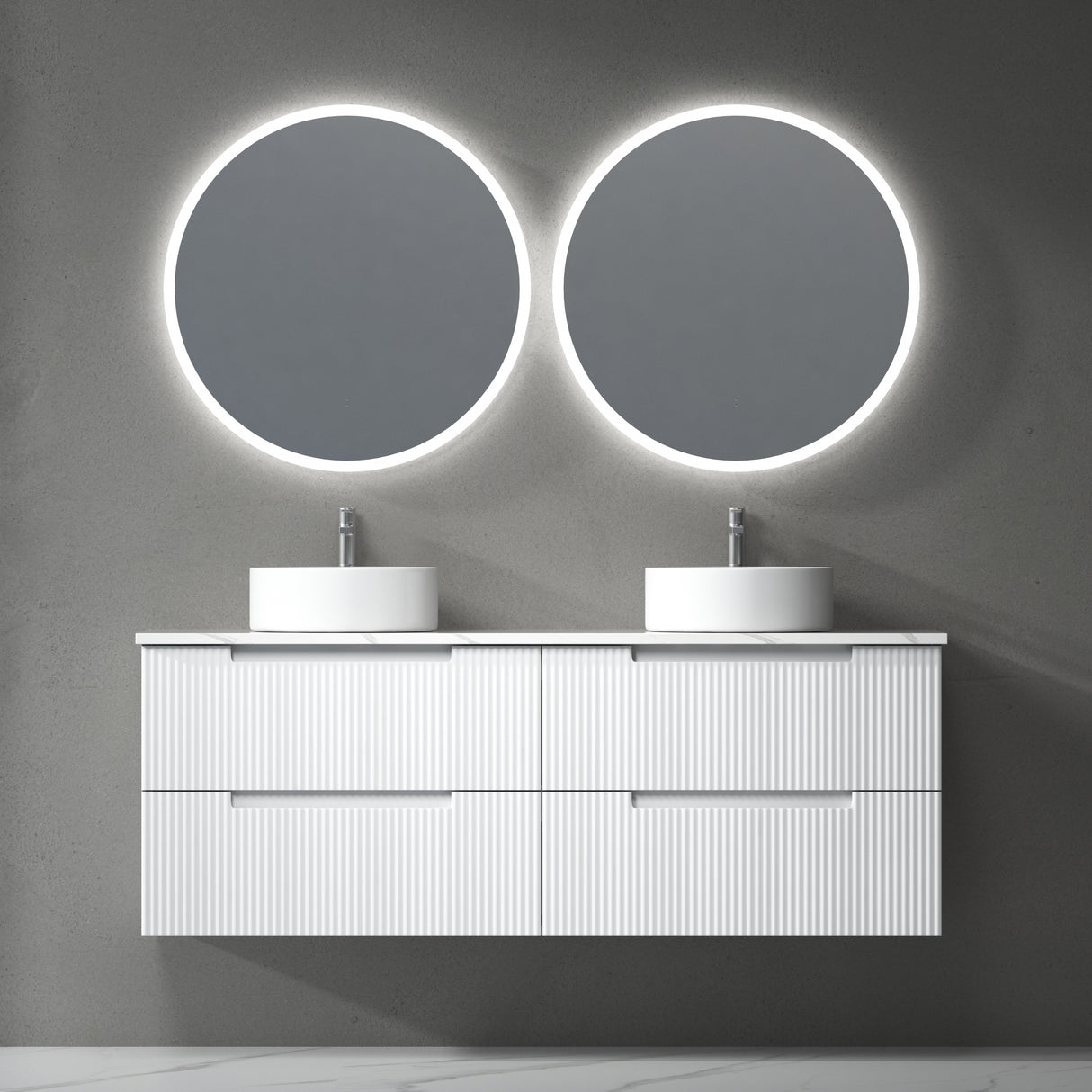 Bathroom vanity with two round illuminated mirrors on a gray wall.