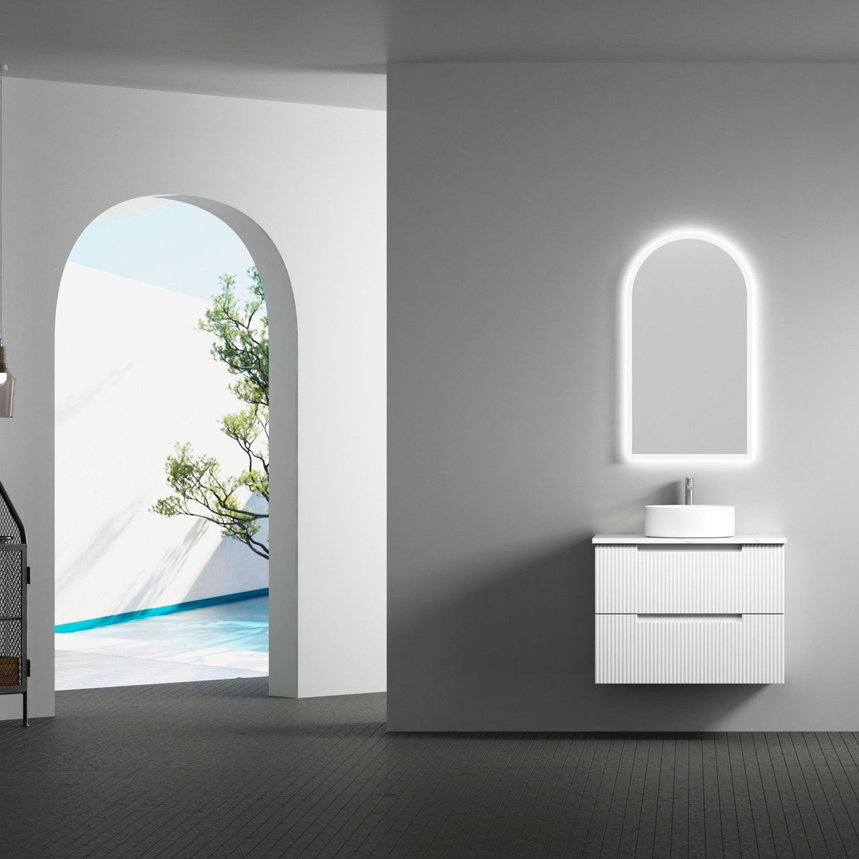 Modern bathroom with a floating vanity and mirror against a gray wall.