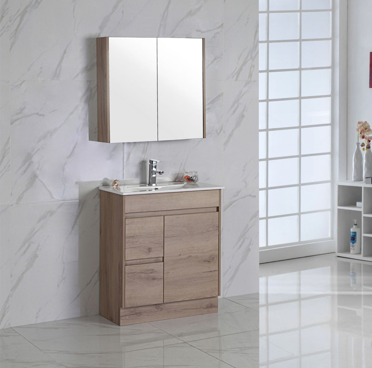 Bathroom vanity with mirror cabinet against a marble wall.