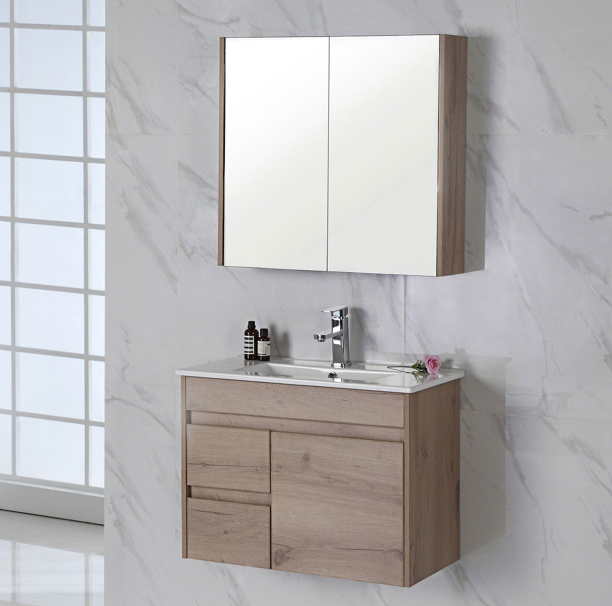 Bathroom vanity right hand drawer with mirror cabinet against a marble wall.
