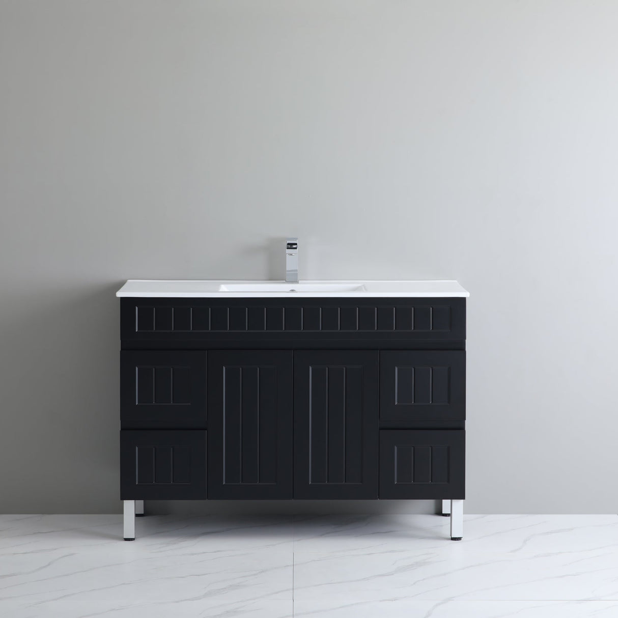 Black bathroom vanity with white countertop against a gray wall