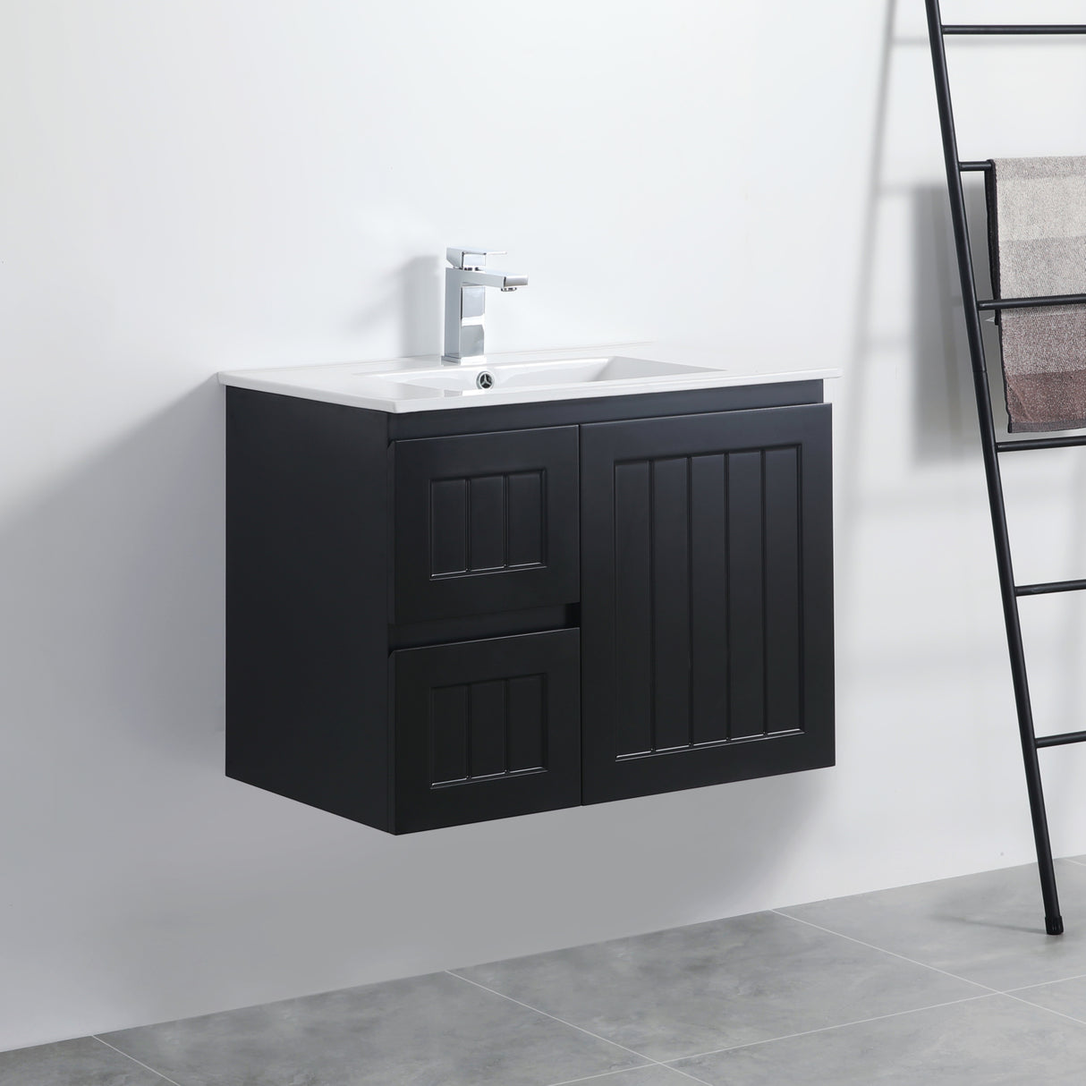 Black bathroom vanity with white sink against a white wall.