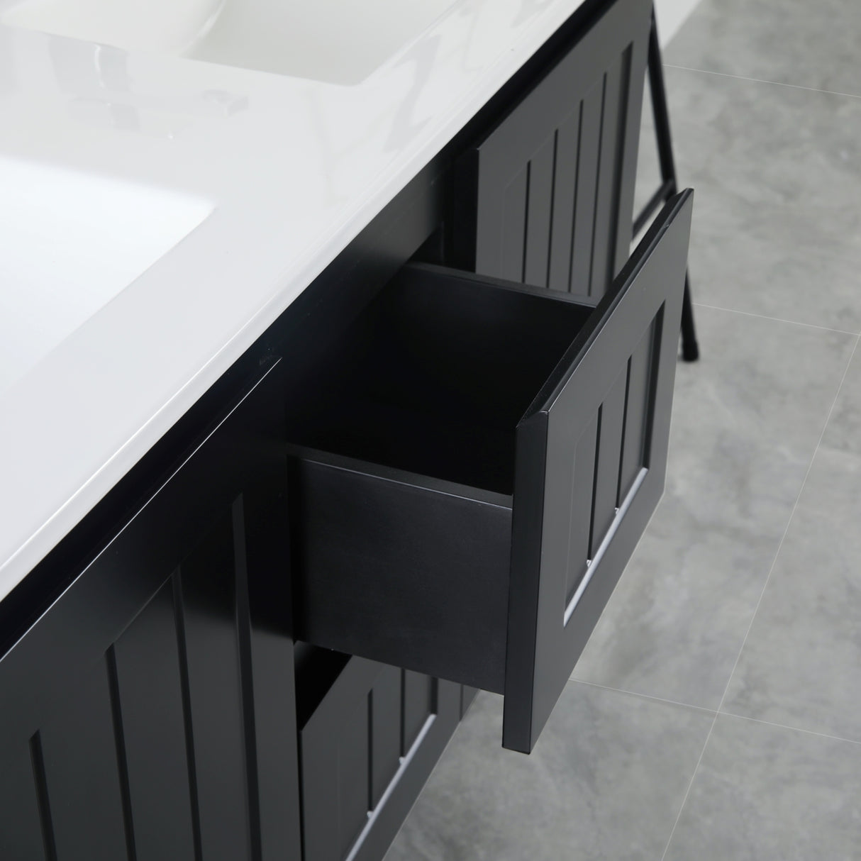 Black drawer with white countertop in a bathroom setting