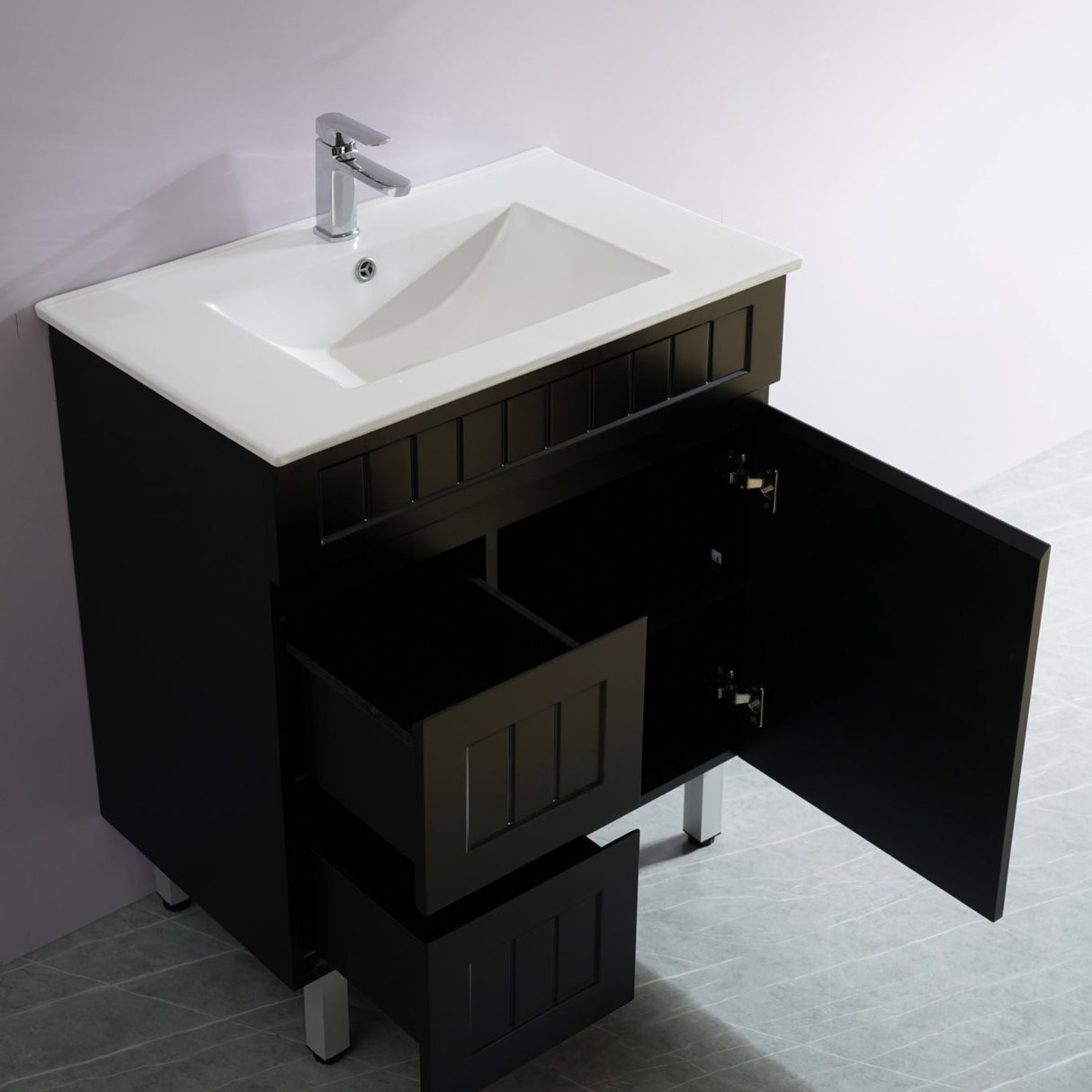 Bathroom vanity with open cabinet doors on a tiled floor.