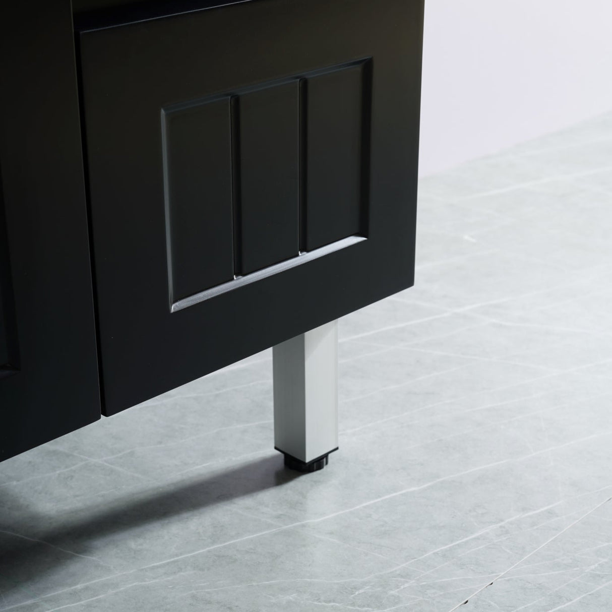 Dark wooden cabinet with a metal leg on a light gray floor